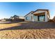 Back of house with covered patio and spacious backyard at 40532 W Wade Dr, Maricopa, AZ 85138