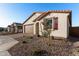 House exterior with brown garage door and red shutters at 40532 W Wade Dr, Maricopa, AZ 85138