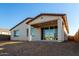 Back of house showcasing patio, sliding doors, and yard at 40532 W Wade Dr, Maricopa, AZ 85138