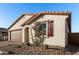 House exterior with brown garage door and red shutters at 40532 W Wade Dr, Maricopa, AZ 85138