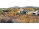 Aerial view of the property with a solar panel, desert landscape, mountain views, and outdoor seating at 6737 E Rockaway Hills Dr, Cave Creek, AZ 85331