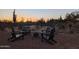 A cozy outdoor firepit area surrounded by desert scenery and chairs at 6737 E Rockaway Hills Dr, Cave Creek, AZ 85331