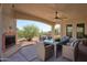 Covered patio with dining area, fireplace, and scenic views at 6737 E Rockaway Hills Dr, Cave Creek, AZ 85331