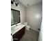 This bathroom features a tile floor, toilet, sink and vanity, and neutral paint at 23671 W Wayland Dr, Buckeye, AZ 85326