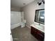 Bathroom with a shower-tub combo, vanity, and tile flooring at 23671 W Wayland Dr, Buckeye, AZ 85326