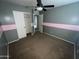 Bedroom featuring gray and pink accent walls with a ceiling fan and closet at 23671 W Wayland Dr, Buckeye, AZ 85326