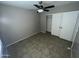 Bedroom with a ceiling fan, and tile flooring, and a large closet at 23671 W Wayland Dr, Buckeye, AZ 85326