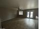 Bright living room featuring tile floors, a ceiling fan, and glass doors leading to the pool at 23671 W Wayland Dr, Buckeye, AZ 85326