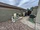 View of the pool equipment with filter, pumps, and plumbing near the backyard wall at 23671 W Wayland Dr, Buckeye, AZ 85326