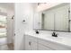 A bright bathroom showcasing double sinks, sleek black hardware, and a large mirror at 40075 W Elm Dr, Maricopa, AZ 85138