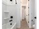 An immaculate bathroom features a white tub and shower, complemented by modern black fixtures at 40075 W Elm Dr, Maricopa, AZ 85138