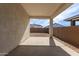 A covered patio with a concrete floor, provides shade and space for outdoor relaxation at 40075 W Elm Dr, Maricopa, AZ 85138