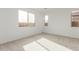 Bright bedroom with neutral-colored carpet and large windows at 40115 W Elm Dr, Maricopa, AZ 85138