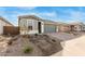 New construction home with attached garage and gravel landscaping at 40115 W Elm Dr, Maricopa, AZ 85138