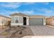 Newly built home with a two-car garage and small front yard at 40115 W Elm Dr, Maricopa, AZ 85138