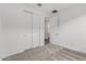 Well-lit bedroom with double door closet and carpet flooring at 40090 W Elm Dr, Maricopa, AZ 85138