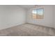 Simple bedroom with carpeted floor and window with natural light at 40090 W Elm Dr, Maricopa, AZ 85138