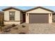 New home exterior with two-car garage and landscaped front yard at 40090 W Elm Dr, Maricopa, AZ 85138