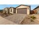 New construction home with a two-car garage and landscaped front yard at 40090 W Elm Dr, Maricopa, AZ 85138