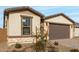 New construction home with a two-car garage and stone accents at 40090 W Elm Dr, Maricopa, AZ 85138