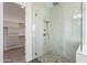 Elegant bathroom showcasing a glass shower with a pebble floor and a closet with shelving at 9626 E Bunny Ear Ln, Gold Canyon, AZ 85118