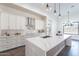 Open kitchen featuring a large island, quartz countertops, stainless steel appliances, and modern lighting at 9626 E Bunny Ear Ln, Gold Canyon, AZ 85118