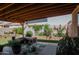 Covered patio with seating area, lush landscaping, and a relaxing atmosphere at 160 S Azteca Dr, Eloy, AZ 85131