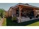 Covered patio with seating area, artificial turf, and lush landscaping at 160 S Azteca Dr, Eloy, AZ 85131