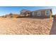 Large backyard with dirt and a view of other homes at 40500 W Wade Dr, Maricopa, AZ 85138