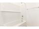 Clean bathroom with a bathtub, shower, and built-in shelving at 40500 W Wade Dr, Maricopa, AZ 85138
