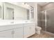 Modern bathroom featuring a double vanity and a glass-enclosed shower at 40500 W Wade Dr, Maricopa, AZ 85138