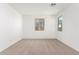 Simple bedroom with neutral carpet and multiple windows at 40500 W Wade Dr, Maricopa, AZ 85138