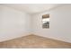 Light and airy bedroom with tile flooring and a window at 40500 W Wade Dr, Maricopa, AZ 85138
