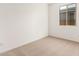 Well-lit bedroom with neutral wall paint and carpeted floor at 40500 W Wade Dr, Maricopa, AZ 85138