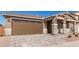 House exterior with brown garage door and stone accents at 40500 W Wade Dr, Maricopa, AZ 85138