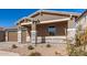 Modern home exterior with a stone facade and landscaping at 40500 W Wade Dr, Maricopa, AZ 85138