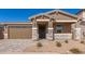 New construction home with stone accents and two-car garage at 40500 W Wade Dr, Maricopa, AZ 85138