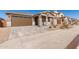 Home exterior showcasing a brown garage door and walkway at 40500 W Wade Dr, Maricopa, AZ 85138