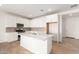 Modern kitchen with island and stainless steel appliances at 40500 W Wade Dr, Maricopa, AZ 85138