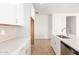 Modern kitchen with white cabinets and a large island at 40500 W Wade Dr, Maricopa, AZ 85138