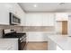Modern kitchen featuring white cabinets and quartz countertops at 40500 W Wade Dr, Maricopa, AZ 85138