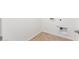 Bright laundry room with wood-look flooring and ample space at 40500 W Wade Dr, Maricopa, AZ 85138