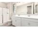 Bathroom with double vanity, a large mirror, and a walk-in shower at 21641 N Daniel Dr, Maricopa, AZ 85138