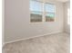 Bedroom with wood-look floors and large windows at 21641 N Daniel Dr, Maricopa, AZ 85138