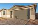 Single-story house with gray exterior and a two-car garage at 21641 N Daniel Dr, Maricopa, AZ 85138