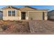 New construction home with attractive curb appeal and two-car garage at 21641 N Daniel Dr, Maricopa, AZ 85138