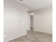 Clean hallway with wood-look floors and door at 21641 N Daniel Dr, Maricopa, AZ 85138