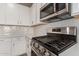Stainless steel gas range and microwave in a modern kitchen setting at 21641 N Daniel Dr, Maricopa, AZ 85138