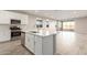 Open concept kitchen with island, stainless steel appliances, and tile flooring at 21641 N Daniel Dr, Maricopa, AZ 85138