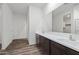 Bathroom with double sinks, wood cabinets, and modern fixtures at 680 W Crowned Dove Trl, Casa Grande, AZ 85122